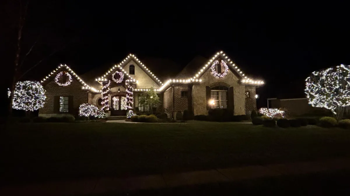 Classic warm white Christmas lights outlining a home roofline