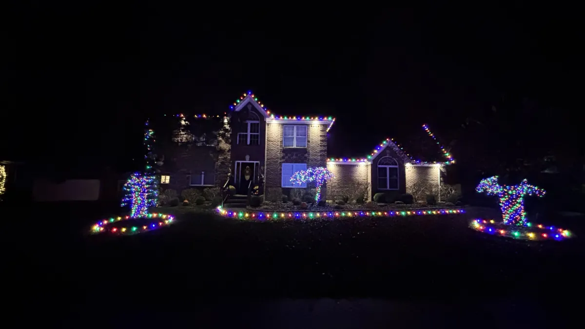 Walkway lined with stake lights and lit garland railings