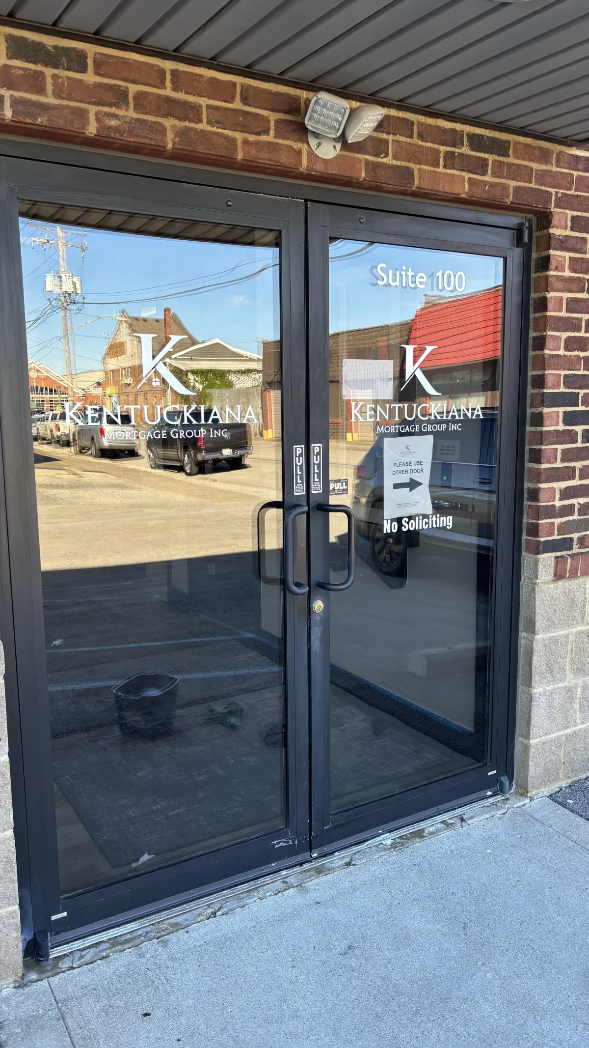 Technician cleaning glass facade of commercial building