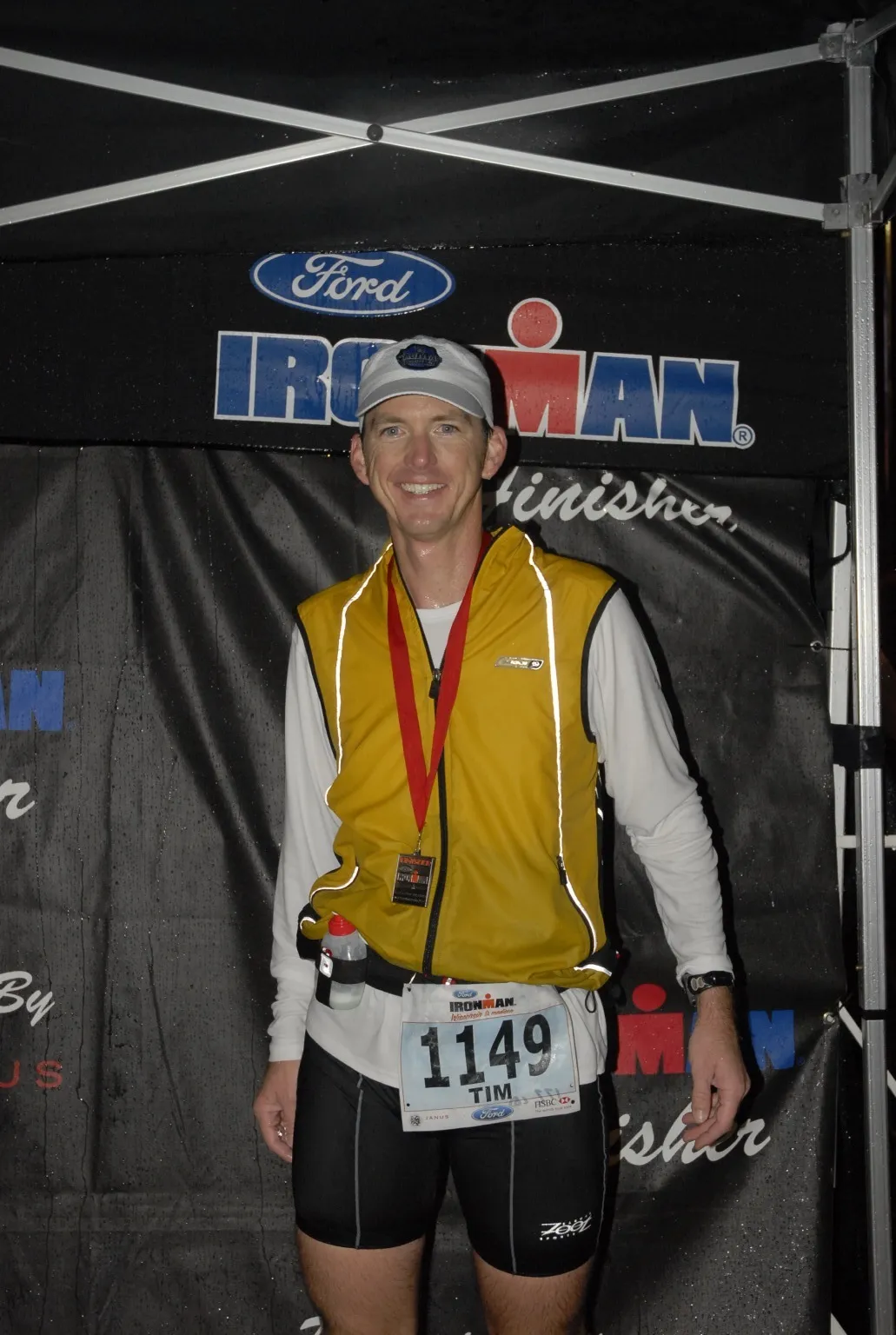 Tim Sorensen at his first Ironman finish in 2008, wearing a finisher medal