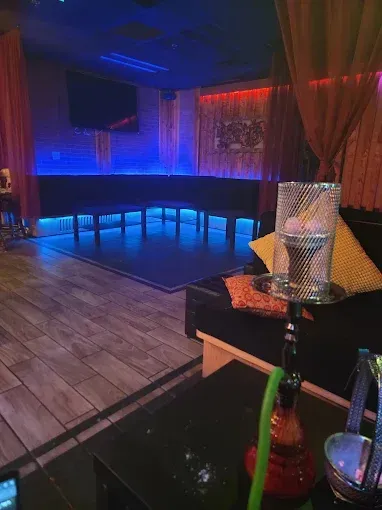 Night view of Sky Cafe & Lounge interior with neon.