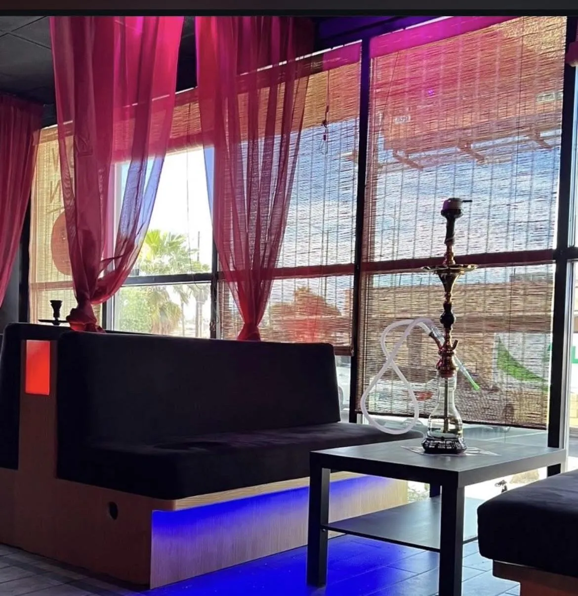 Night view of Sky Cafe & Lounge interior with neon.