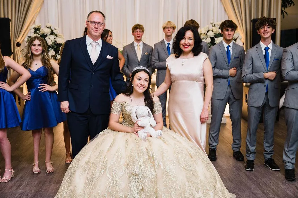 Mia Sheets with her parents during her quinceañera presentation in Louisiana, smiling together