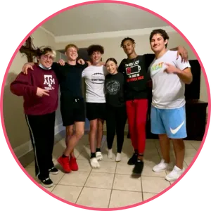 Jordan the quinceañera and her chambelanes posing in her living room after dance practice