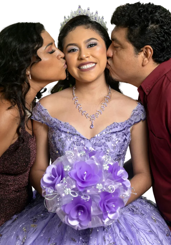 Quinceañera smiling in her dress as both parents kiss her on the cheek — a sweet, emotional moment from her celebration.