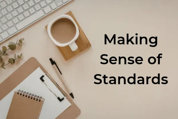 Desk with a notebook, pen, keyboard, and coffee beside the title Making Sense of Standards.