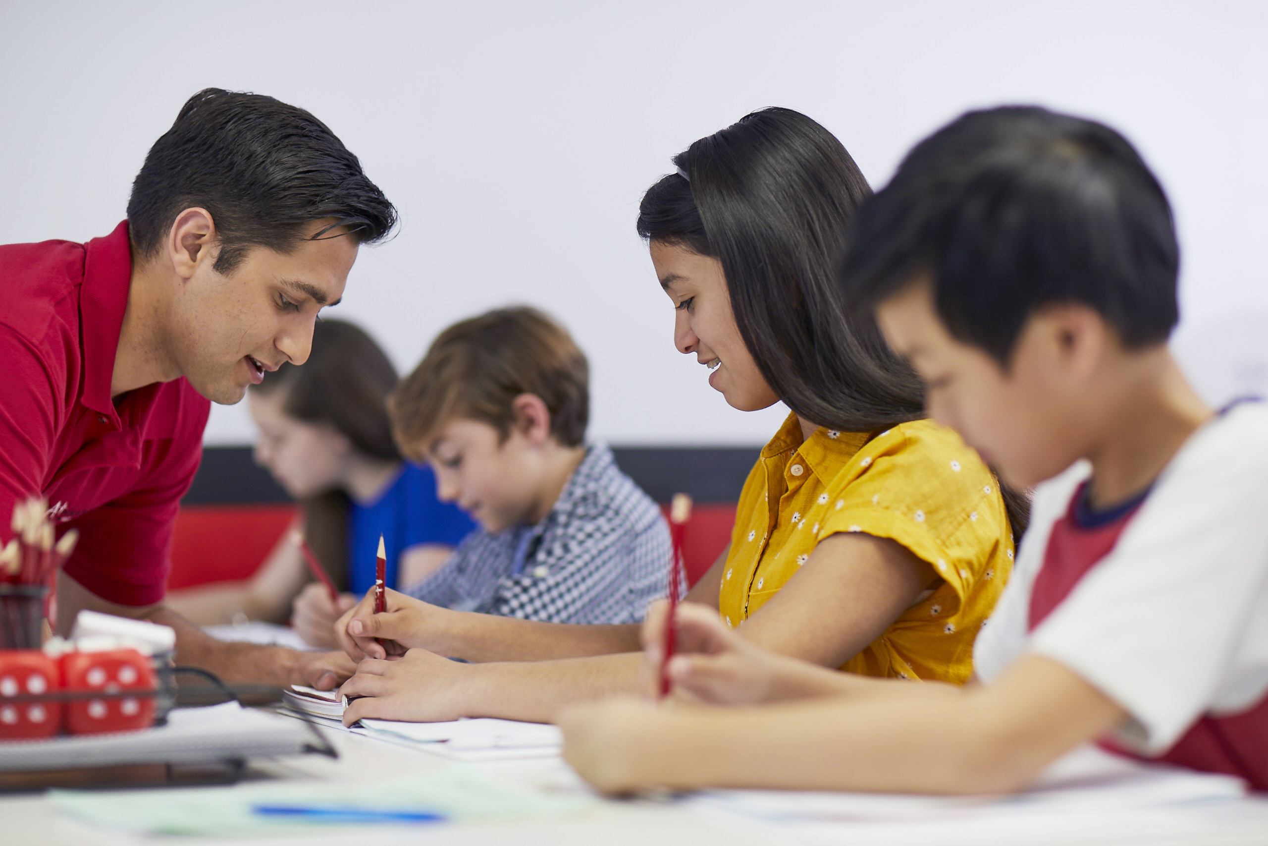 Smiling high school student engaged in an encouraging tutoring session with a dedicated mentor