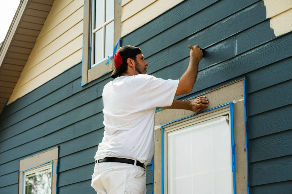 AMG Construction & Landscaping crew painting residential exterior siding in Kearns, Utah for a smooth and lasting finish