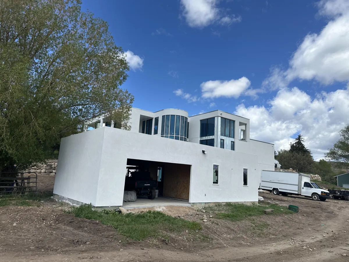 Modern residential exterior project completed by AMG Construction & Landscaping in Kearns, Utah featuring stucco, siding, and stone finishes