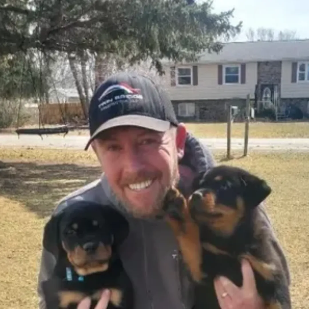 Twin Bridge Roofing & Construction owner with company dogs in the Quad Cities