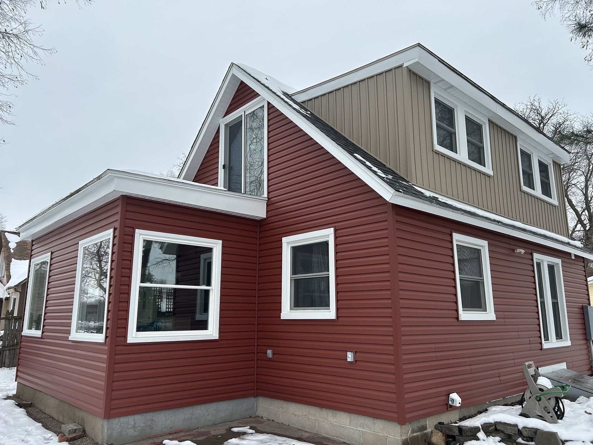 Roof and siding installation by Twin Bridge Roofing & Construction on residential home