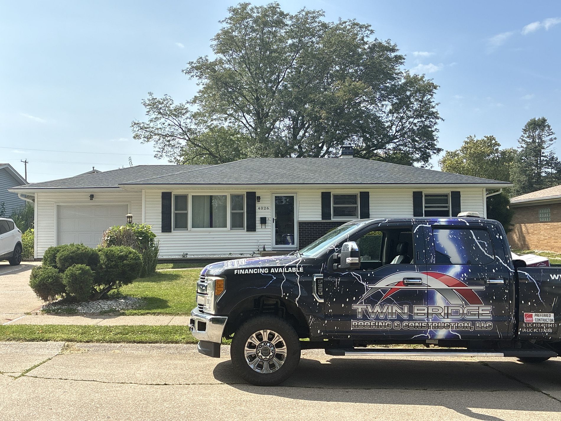 Completed roofing project with Twin Bridge Roofing & Construction service truck on site