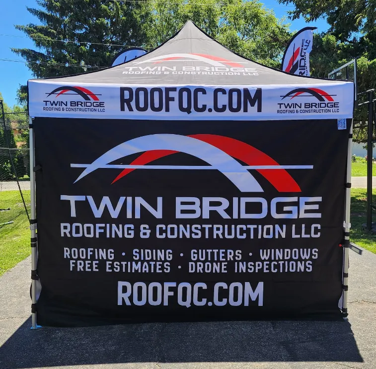 Twin Bridge Roofing & Construction community event tent showcasing local roofing, siding, and exterior services in the Quad Cities