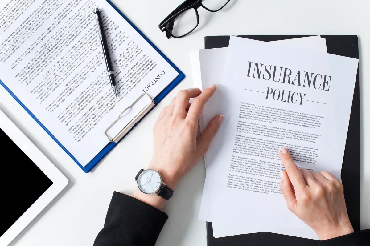 Homeowner reviewing insurance claim paperwork for roof depreciation payout