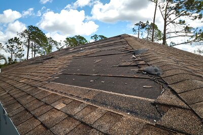 Wind and storm damaged roof shingles on a Bettendorf home