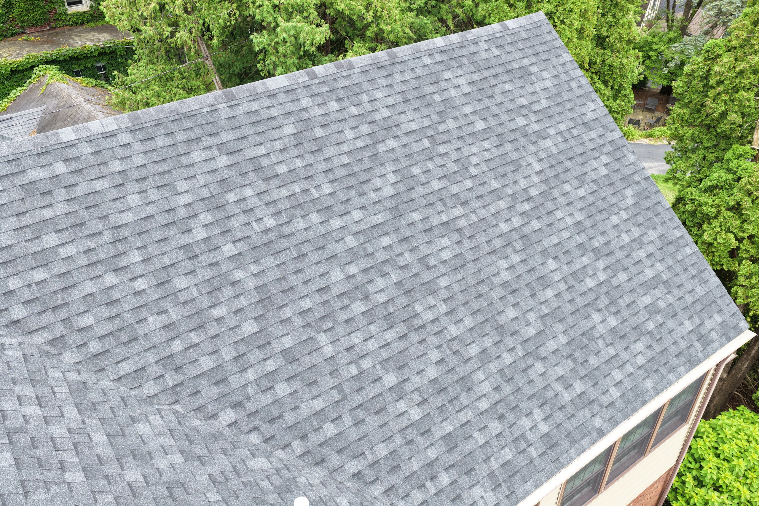Quad Cities roof damaged by August heat with curled shingles and sun exposure
