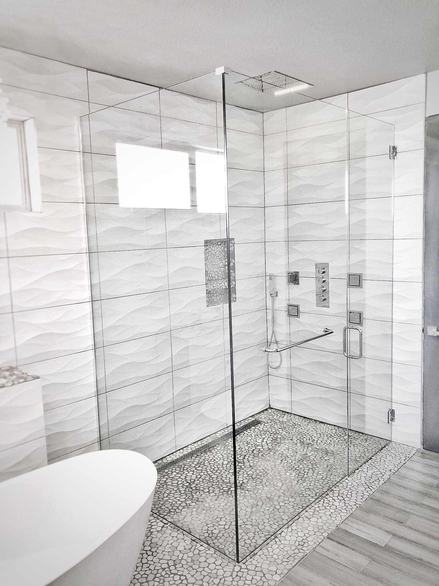 Curbless Glass Shower Door Enclosure with a towel bar