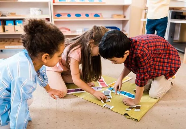 Children playing happily in a bright, colorful classroom at Sugar n Spice Daycare & Kindergarten