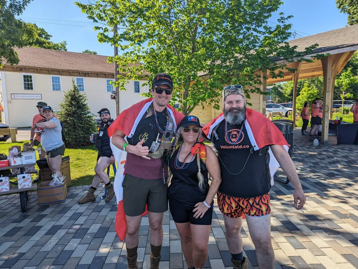 a group of people standing in the snow at night