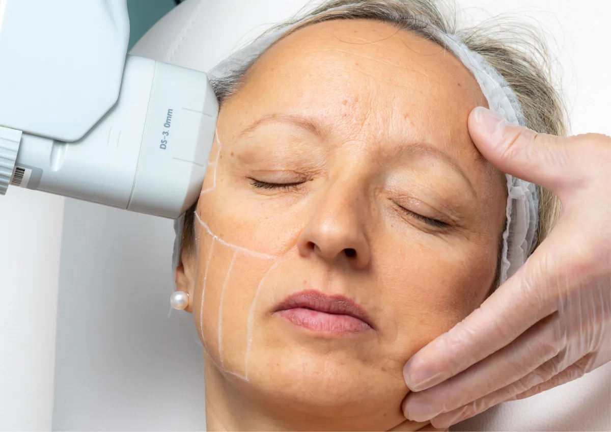 woman sitting on dock bridge near lake during daytime