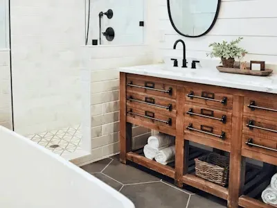 Renovated bathroom in Rockville MD features a freestanding tub, walk-in shower, and modern fixtures in soft neutrals.