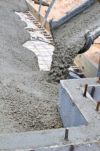 Vacuum truck performing industrial cleaning and waste removal at loading dock facility