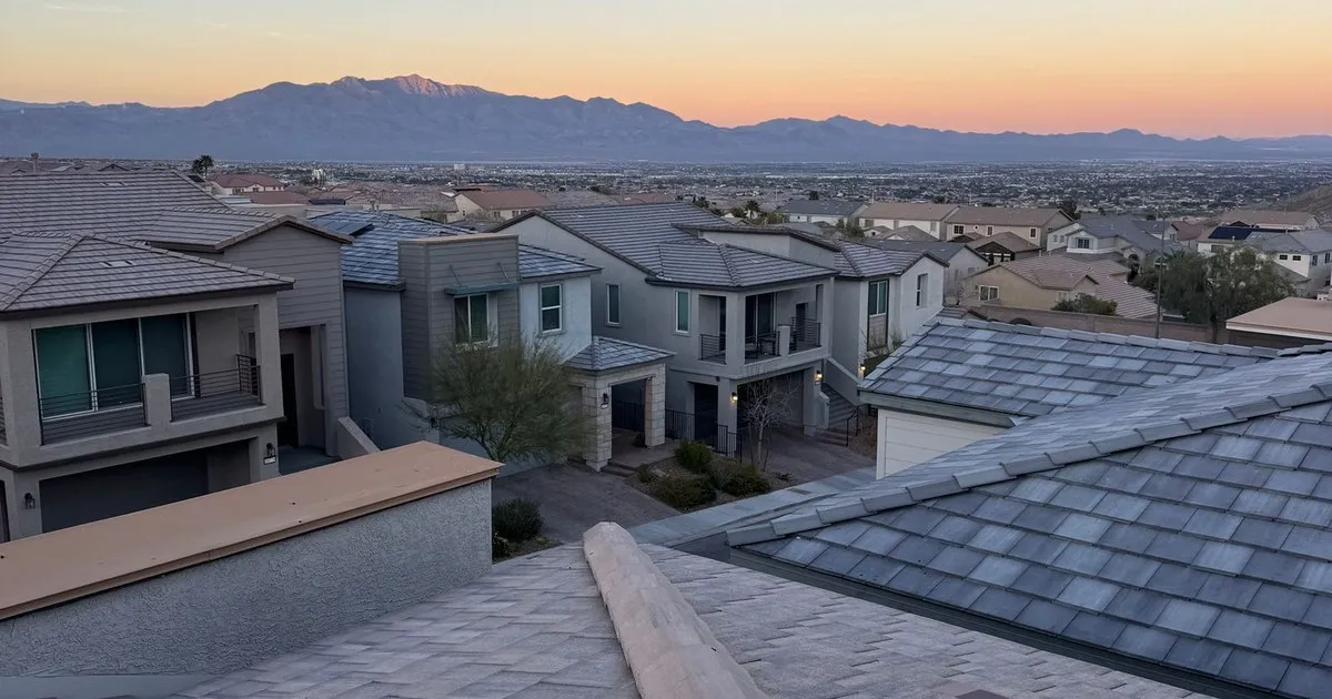 Rooftops of a suburban neighborhood in Northwest Las Vegas at sunset with mountains in the distance