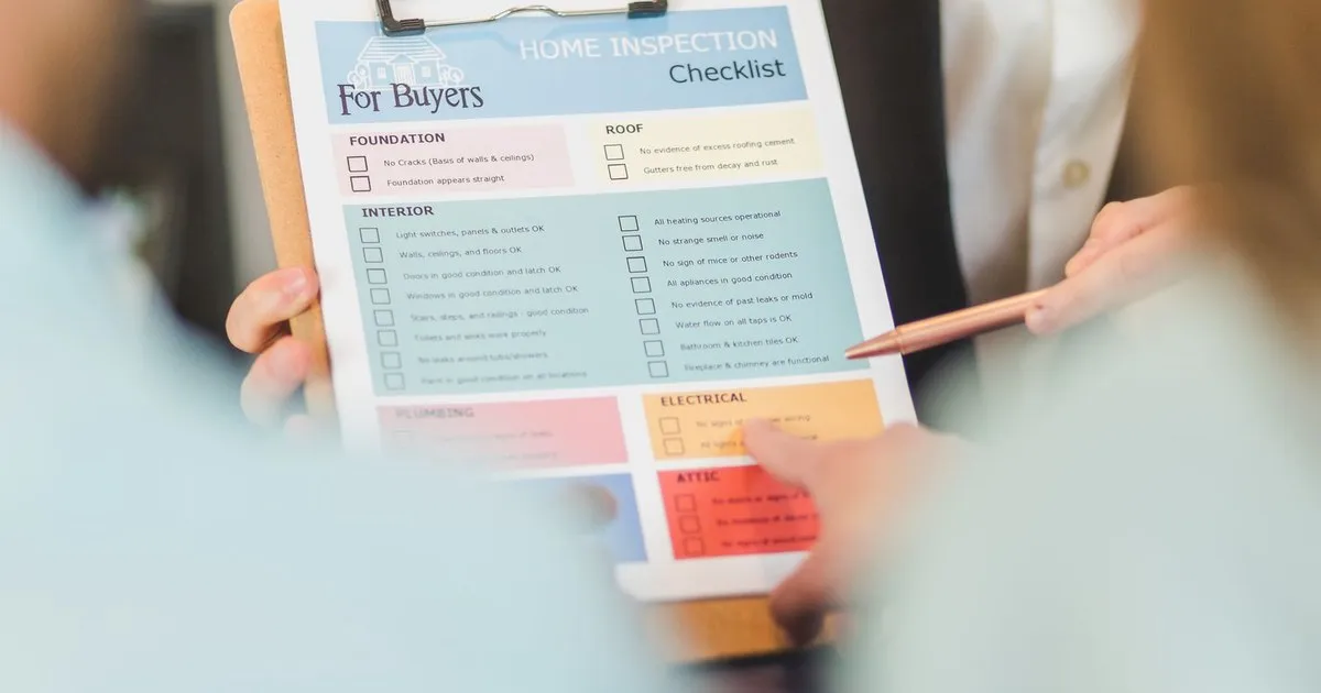 A home inspection checklist on a clipboard with sections for foundation, roof, interior, and electrical