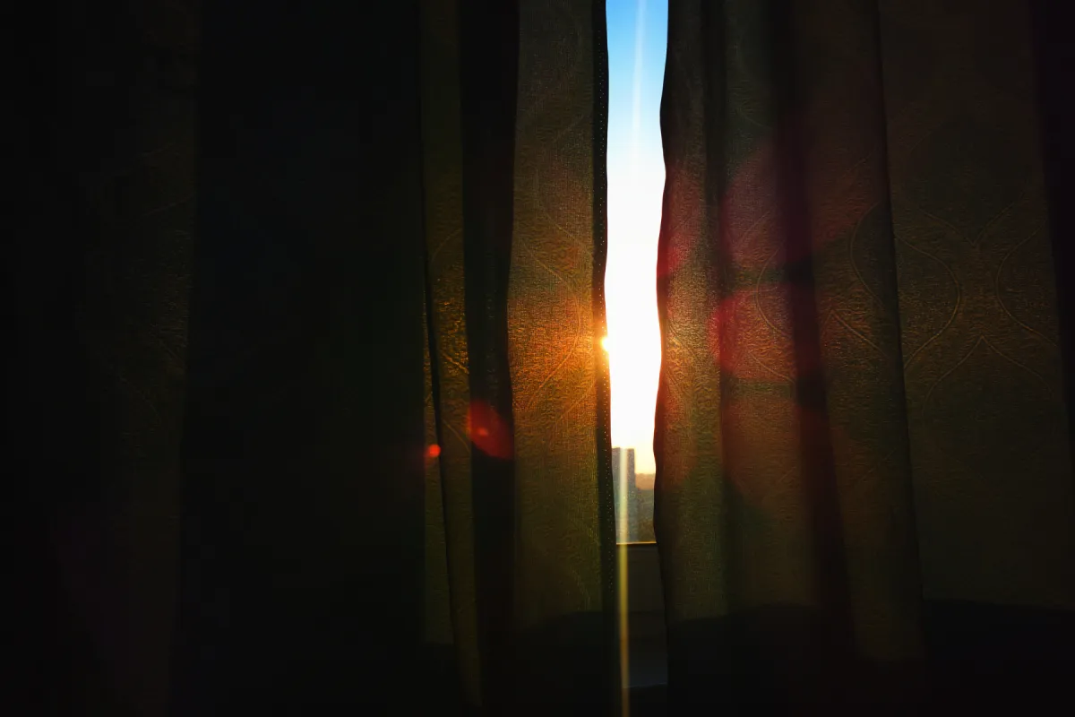 Curtains with light peering through