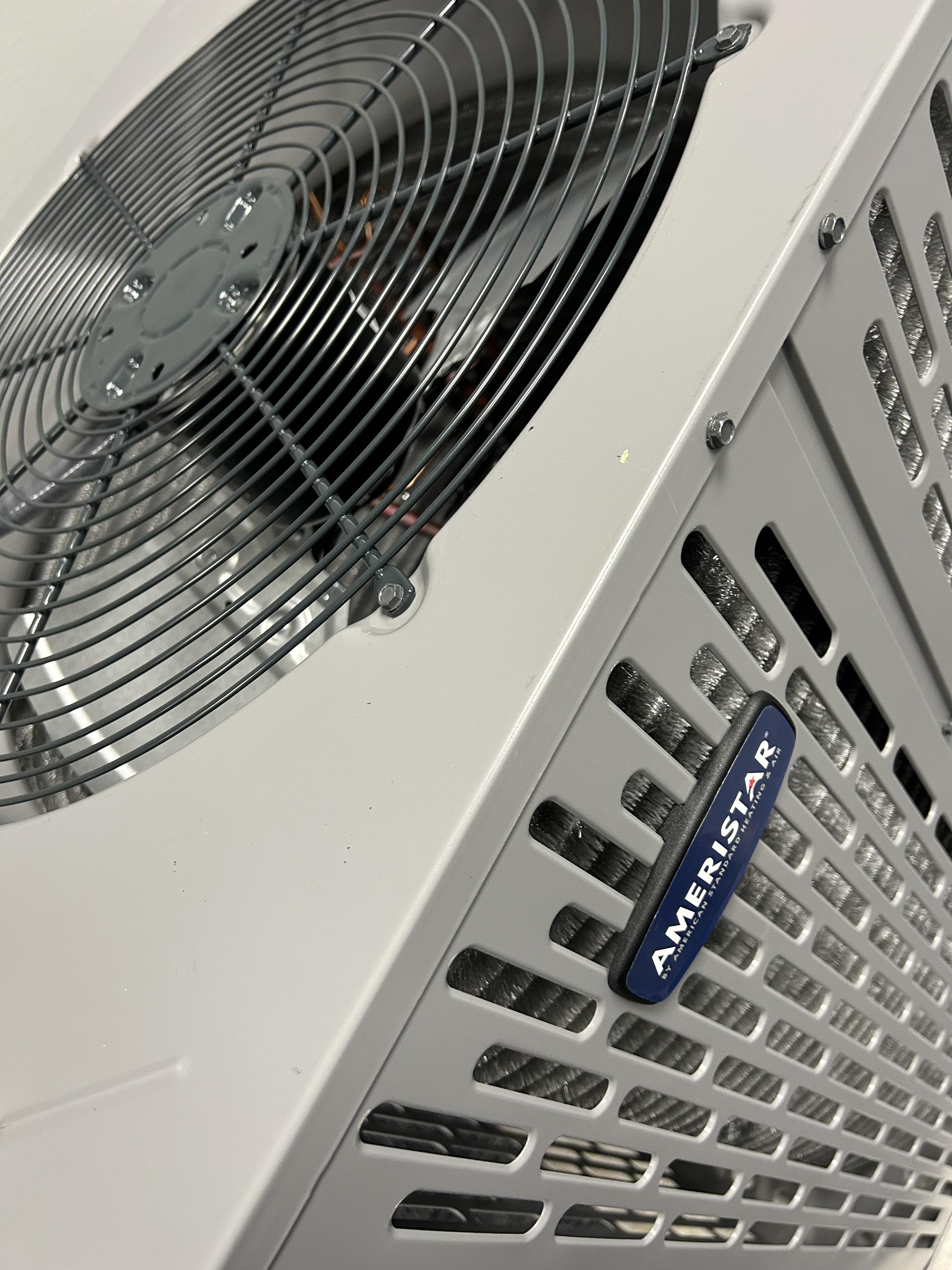 Air conditioning unit with Ameristar branding, featuring a fan and metal casing, emphasizing energy efficiency and reliable cooling solutions for residential HVAC needs in Oklahoma City.