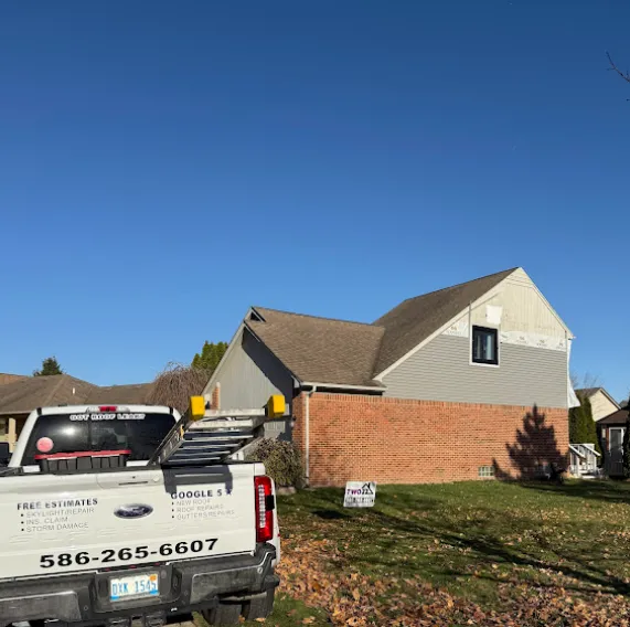 a man standing on the roof of a house