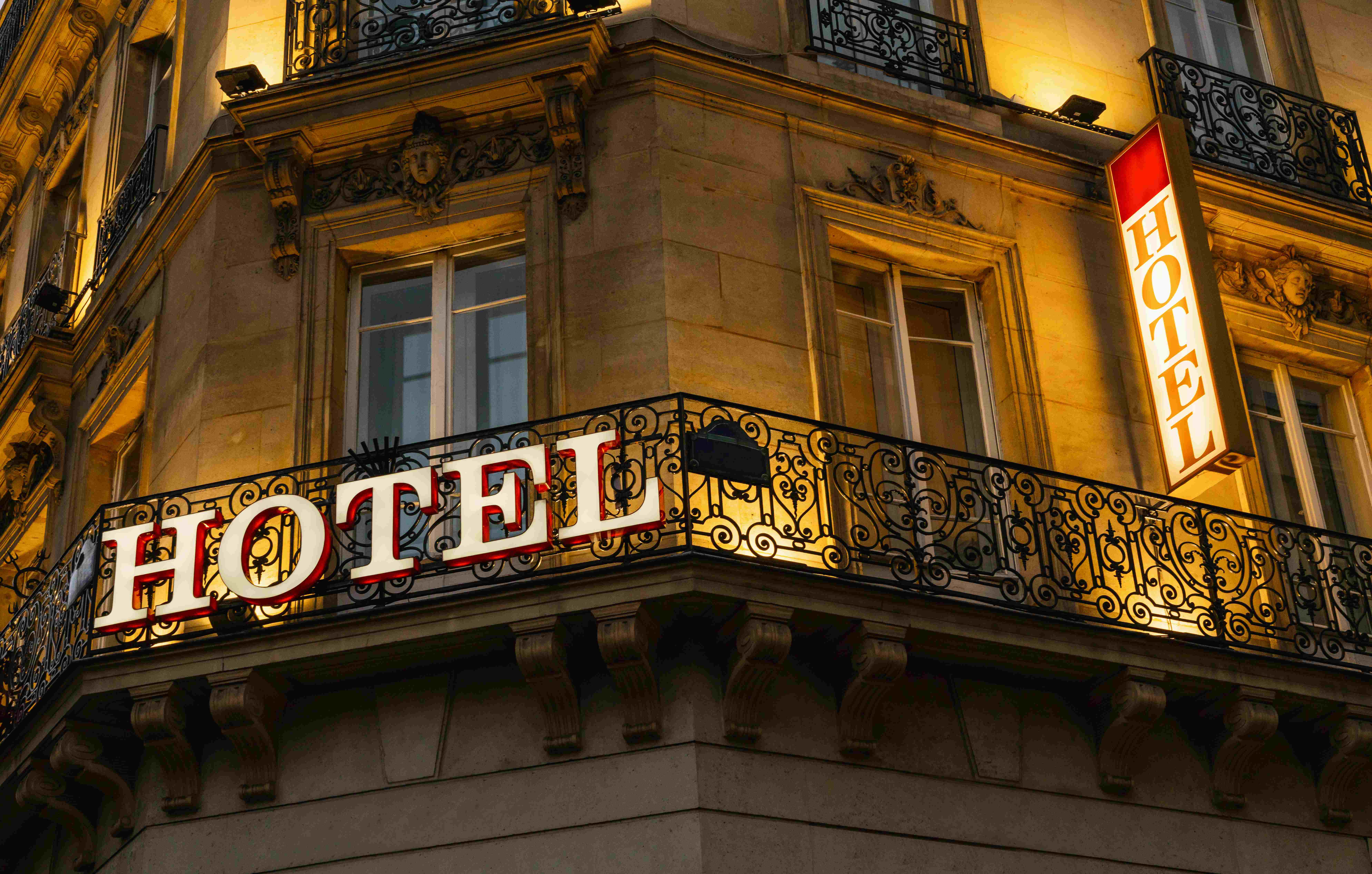 New York City hotel exterior with a Safe Hotels Act compliance license displayed at the entrance
