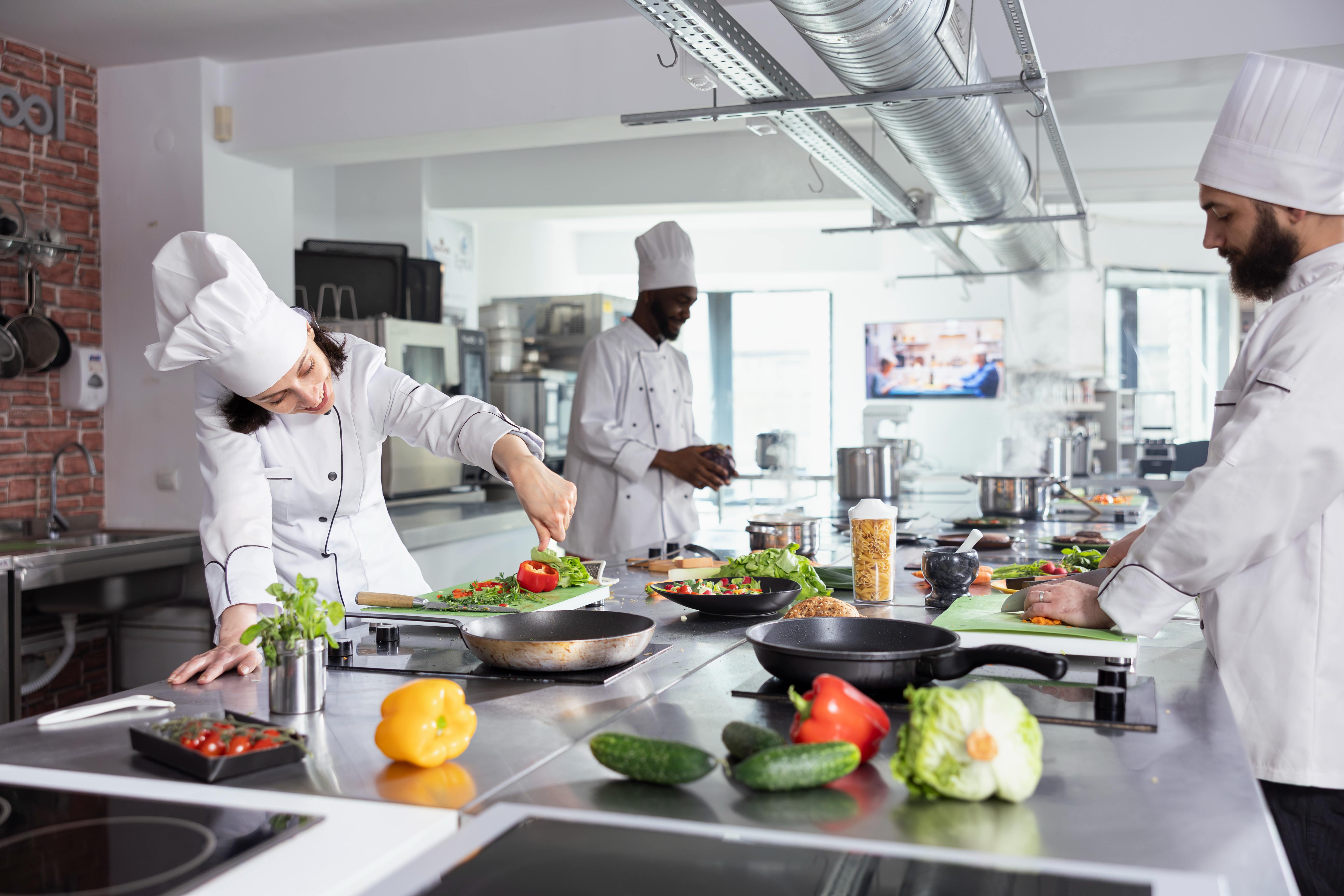 Hotel kitchen staff preparing food during a busy service