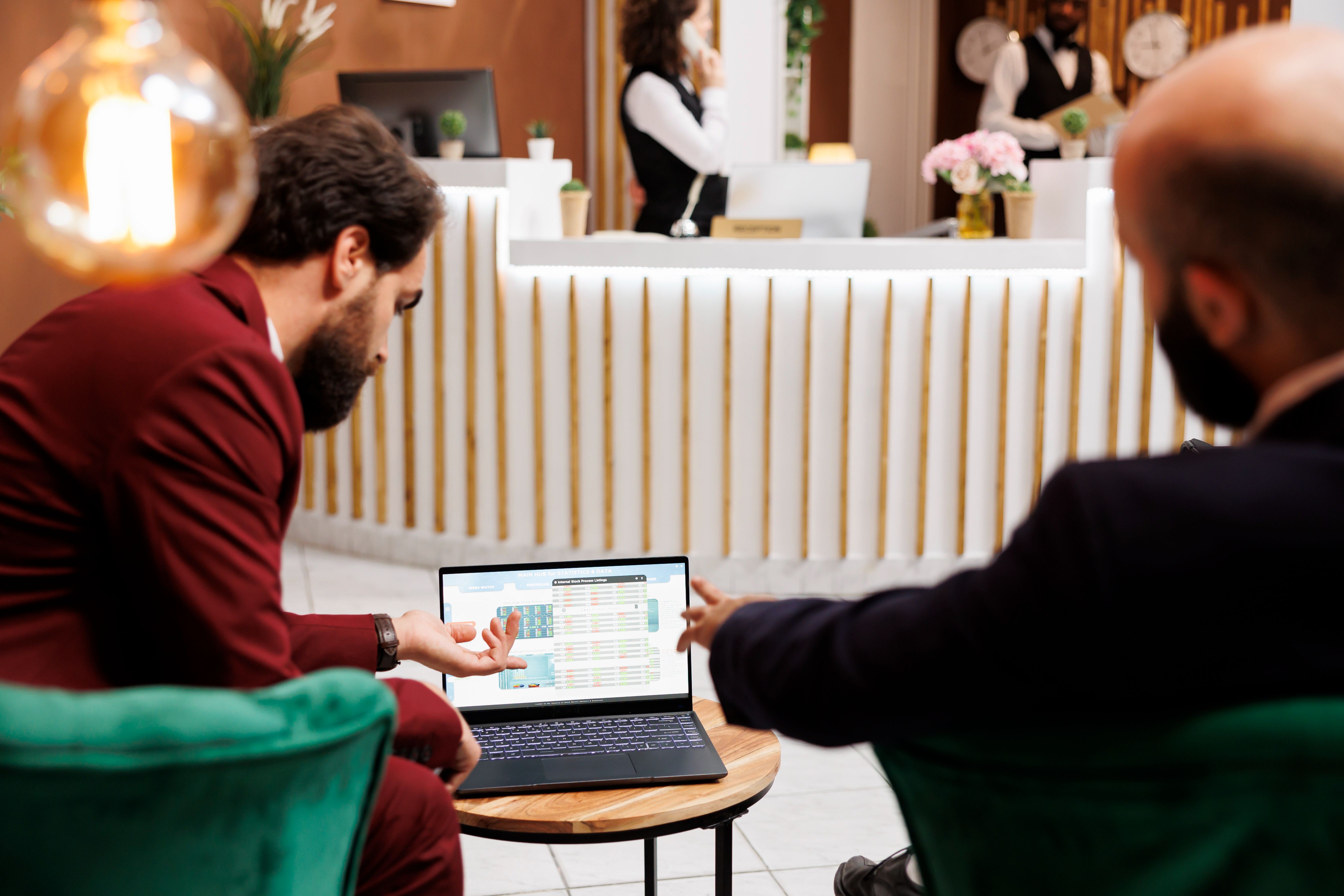 Hotel finance manager reviewing cost per occupied room data on a laptop