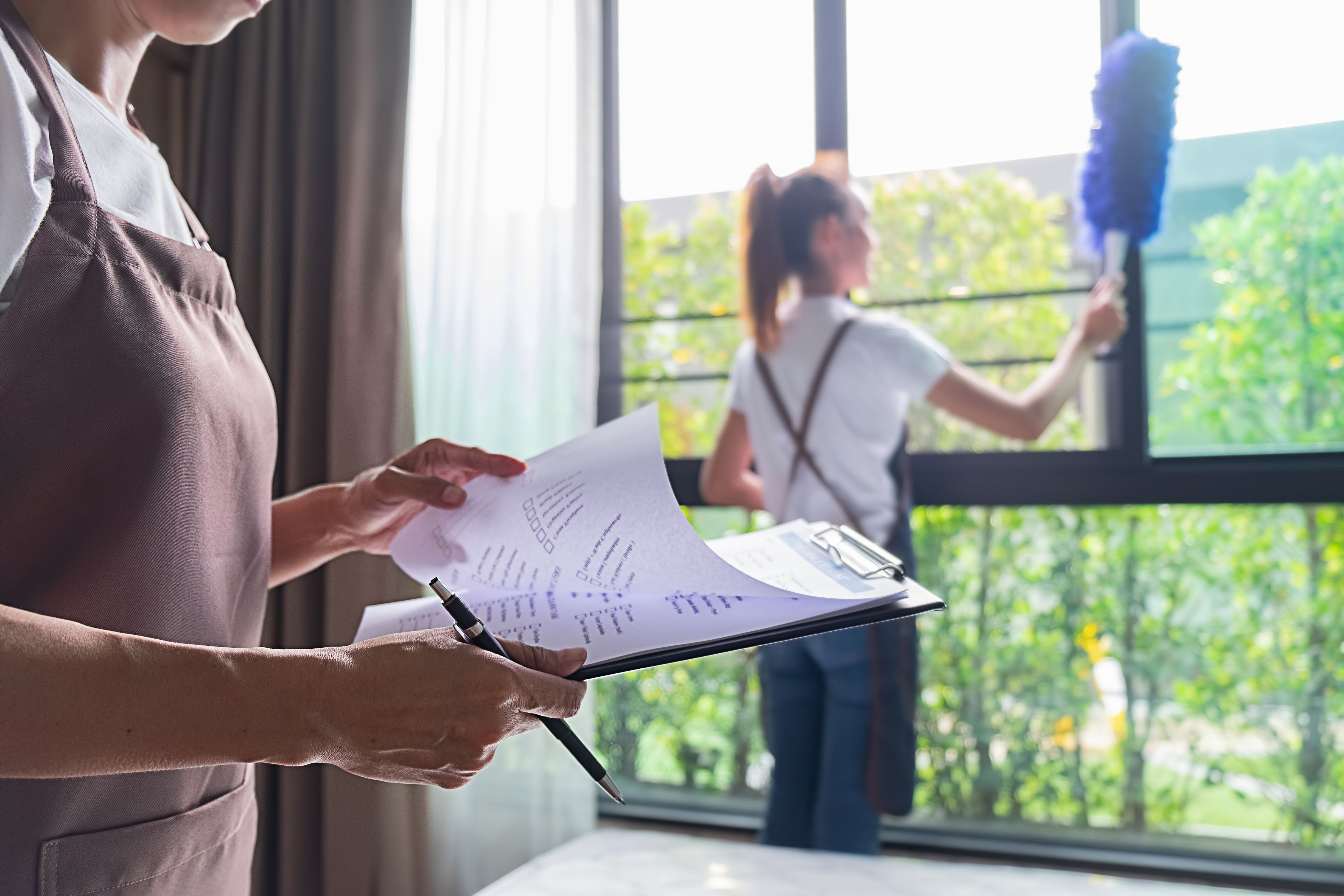 Hotel owner reviewing a renovation and cleaning timeline with a contractor