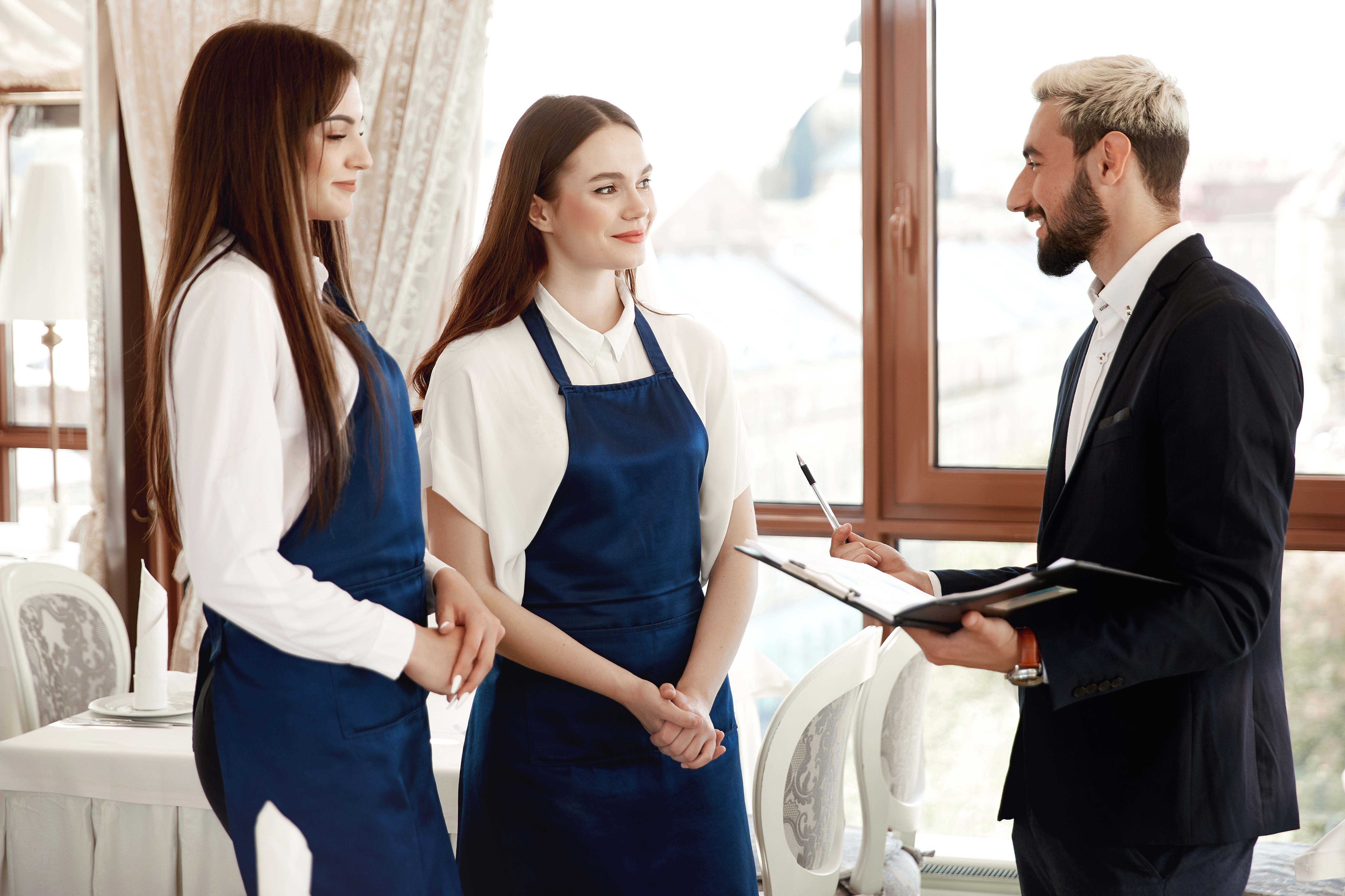 Hotel manager thanking a housekeeping team member in a hallway