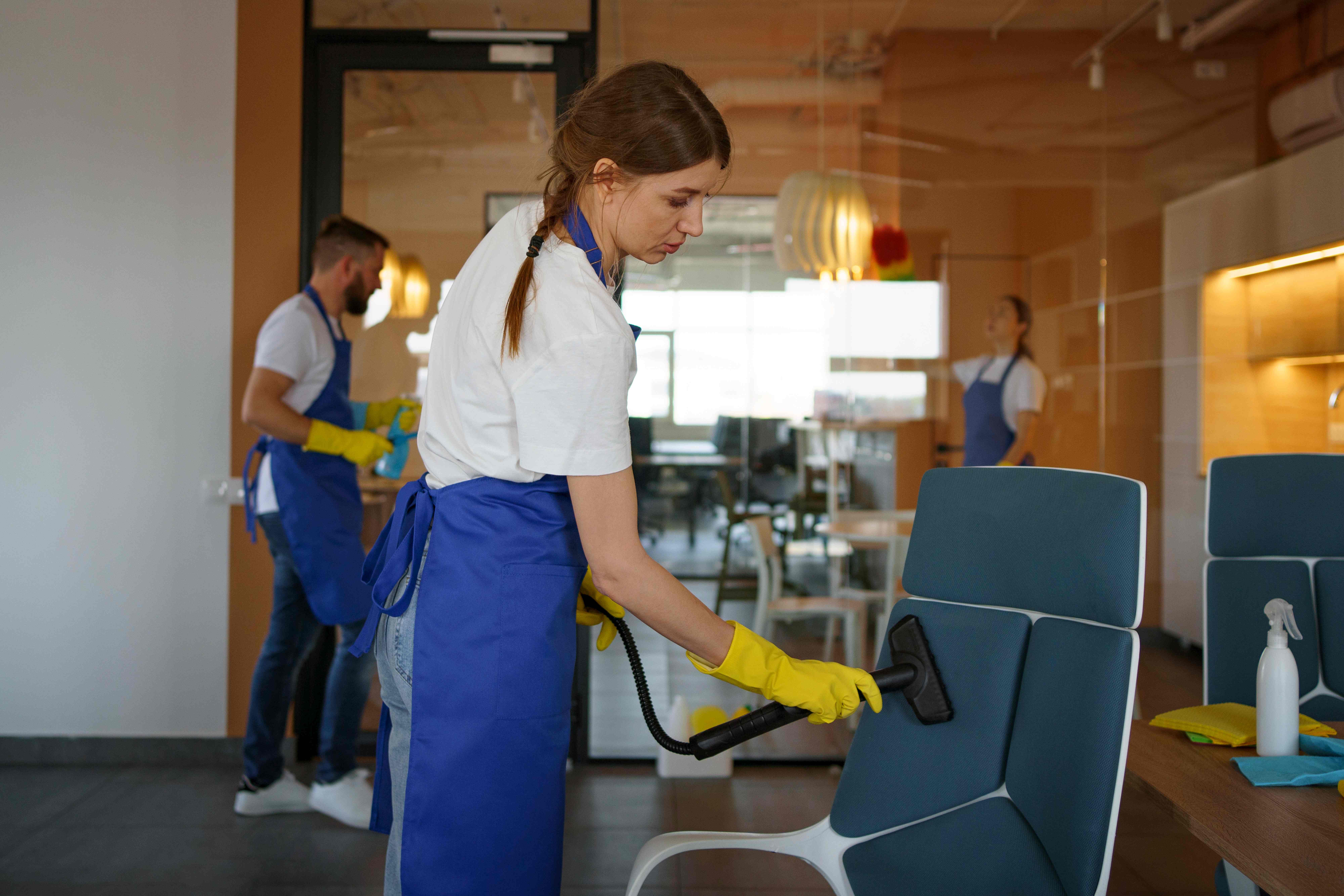Professional cleaning staff sanitizing a commercial facility common area