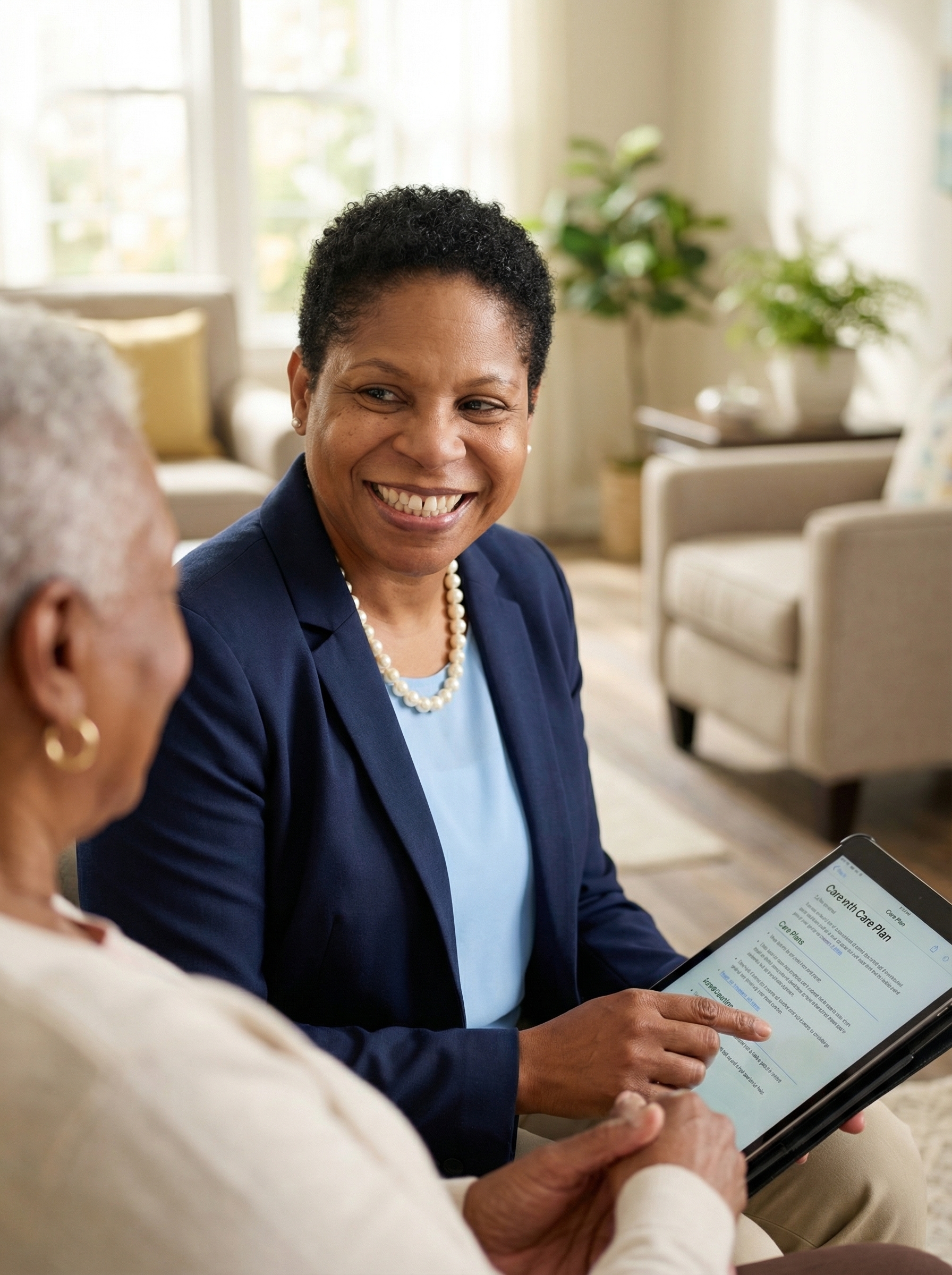 A young Latina caregiver with short hair, wearing a beige top, stands in a hallway holding a clipboard.