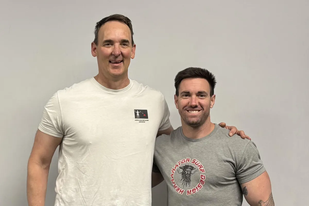 Coach guiding client through strength training session