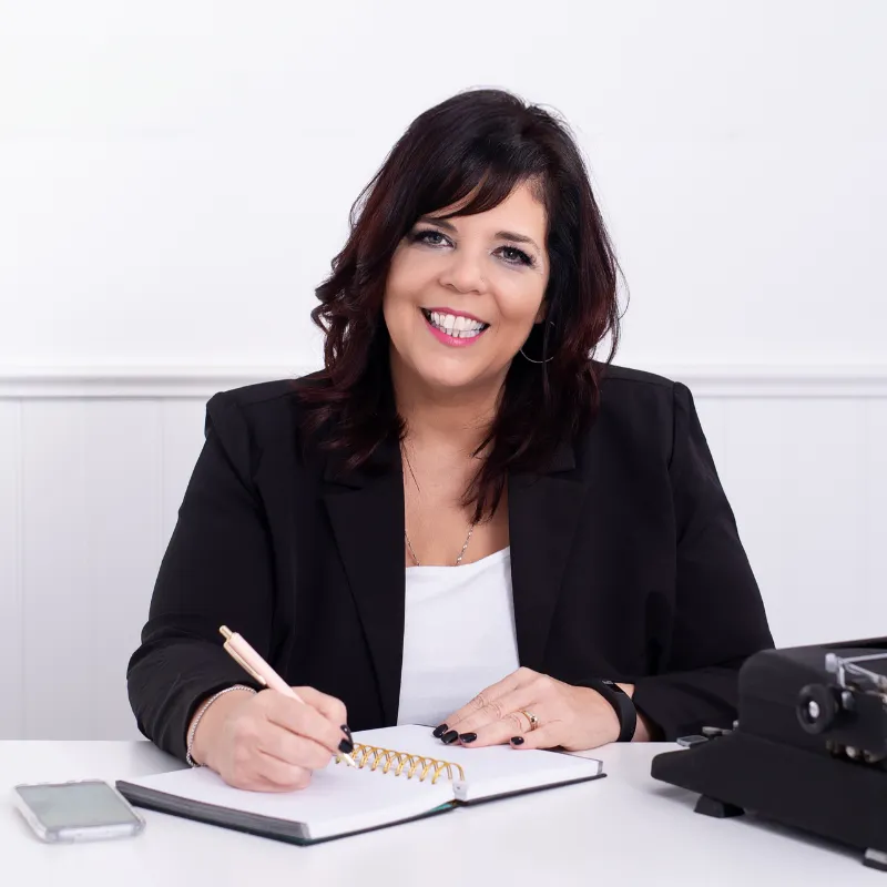 Robyn Bennett at desk writing in notebook