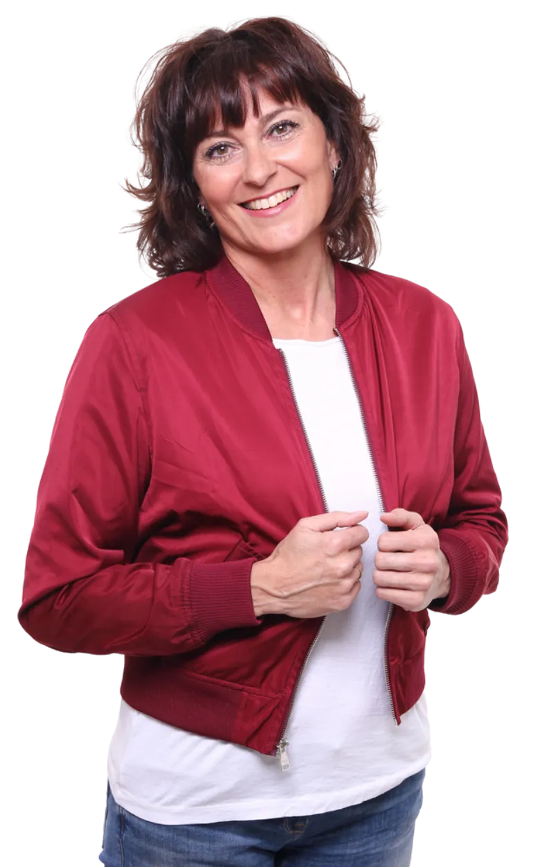 Smiling woman in red jacket, hands in pockets