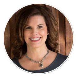 Cyndi Lynne smiling with curly hair, intuitive life coach
