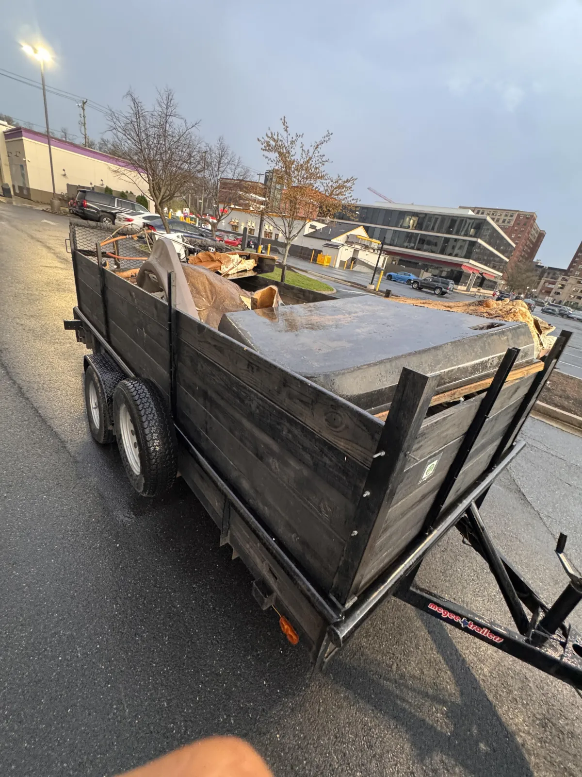 trailer of junk carrying hot tub debris in silver spring md