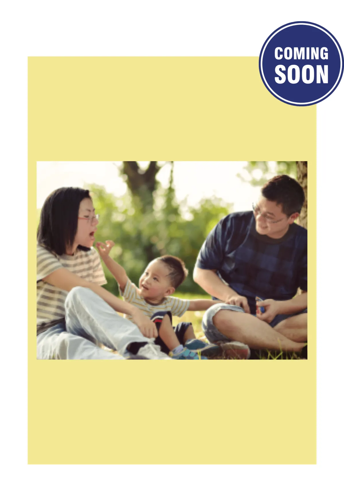 A family enjoys a sunny day on the grass, sitting together with their baby, fostering connection and joy in nature.
