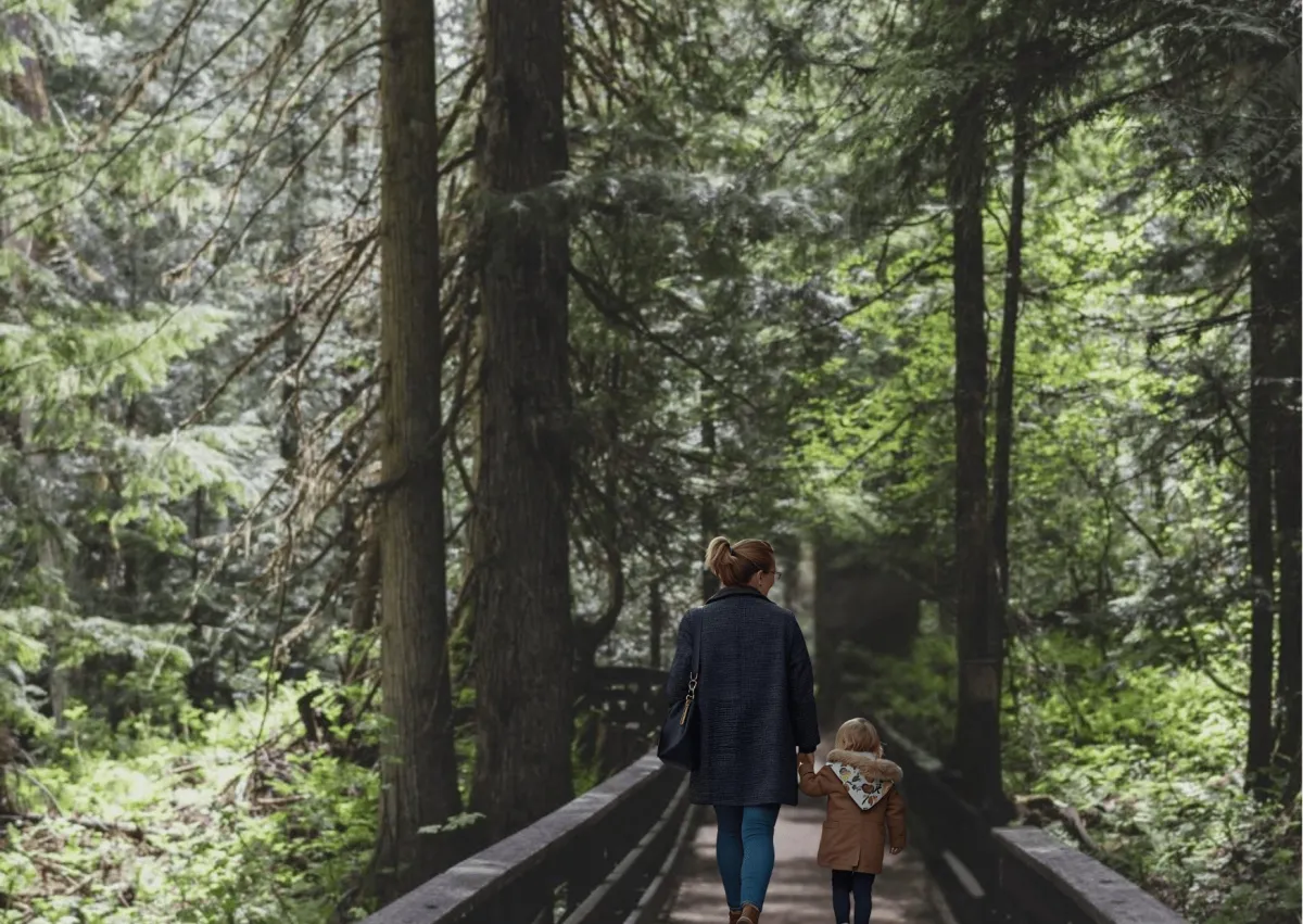 Child swinging with parents in Northern British Columbia, Paths 2 Communication Laura Hutchinson SLP