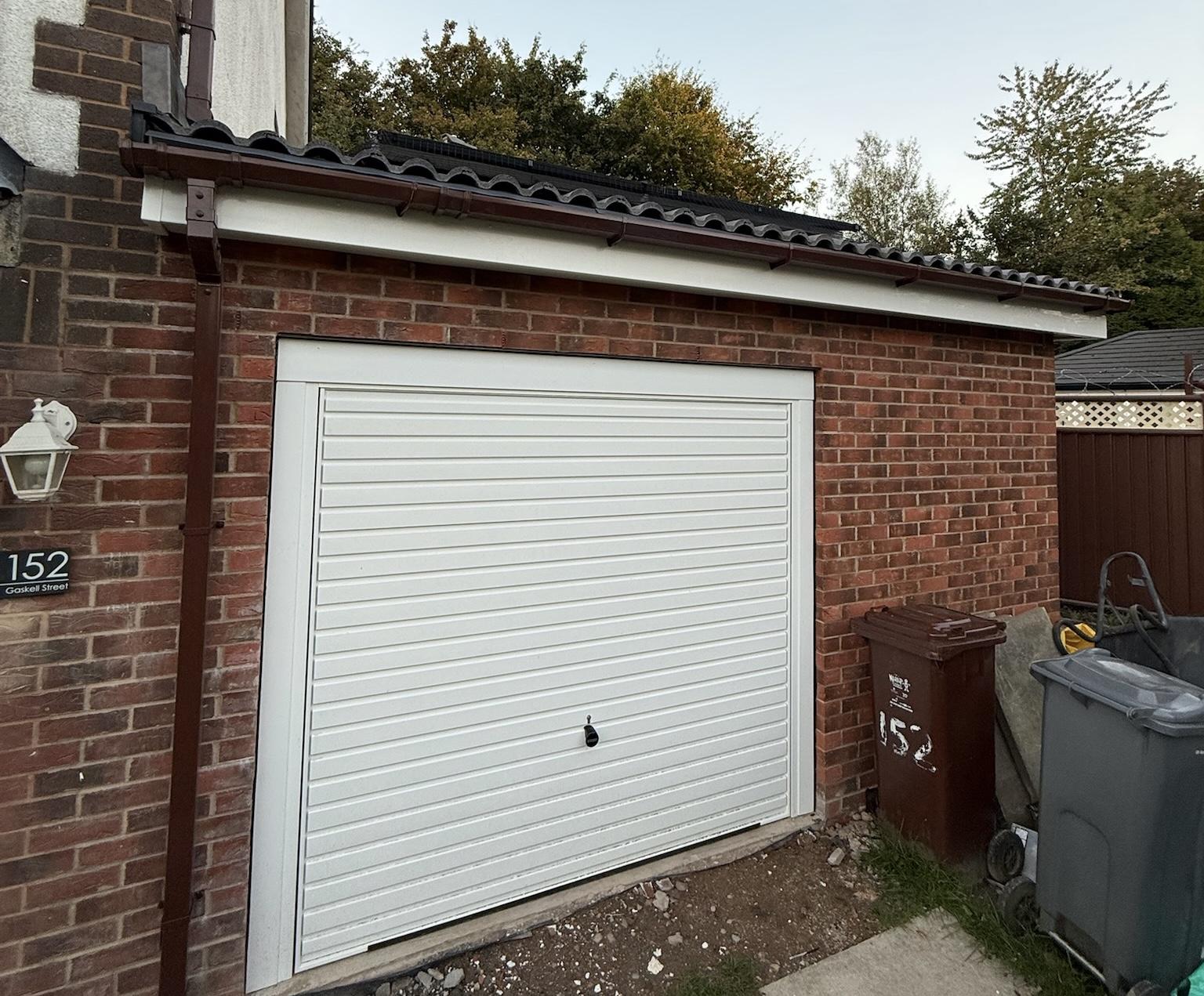 Garage conversion in Newton Heath with the original garage door retained to maintain front storage space and external appearance