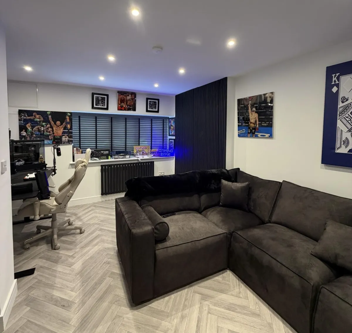 Double garage conversion transformed into a modern family games room with a home office, herringbone flooring, feature panelling and spacious open plan layout.