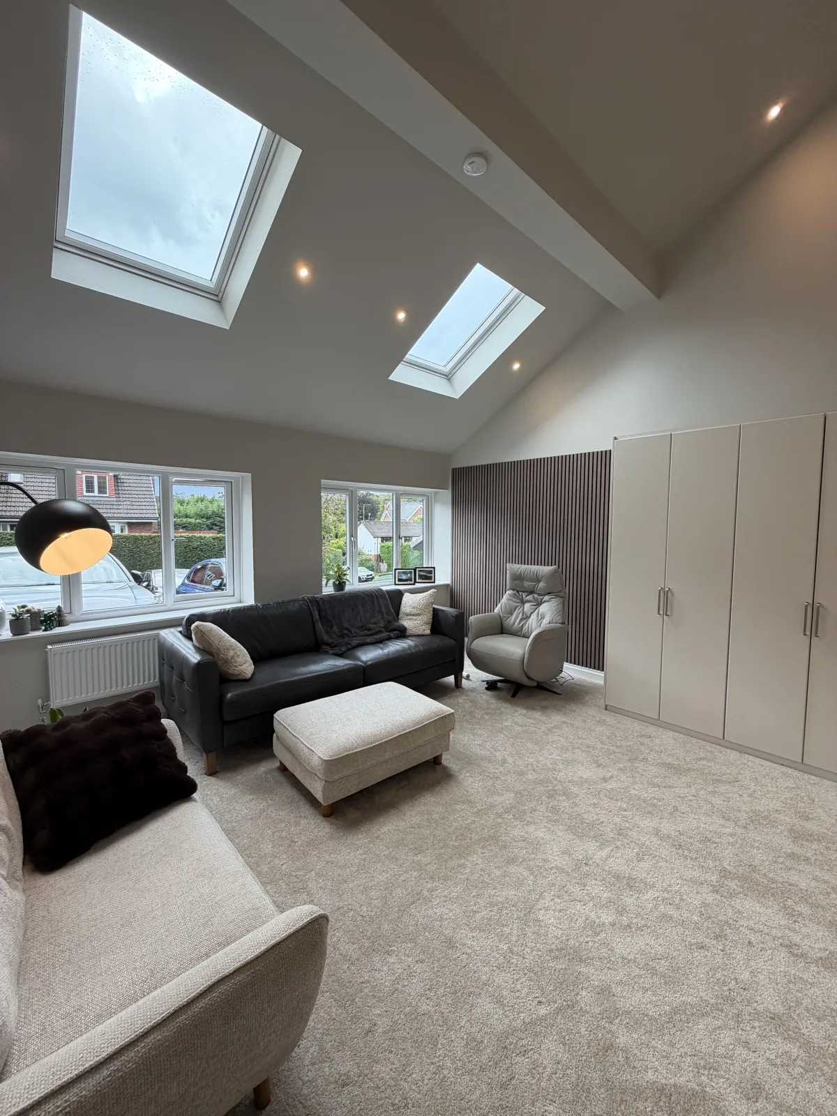 Double garage conversion in Bolton transformed into a spacious living room with skylights, vaulted ceiling and additional family living space.