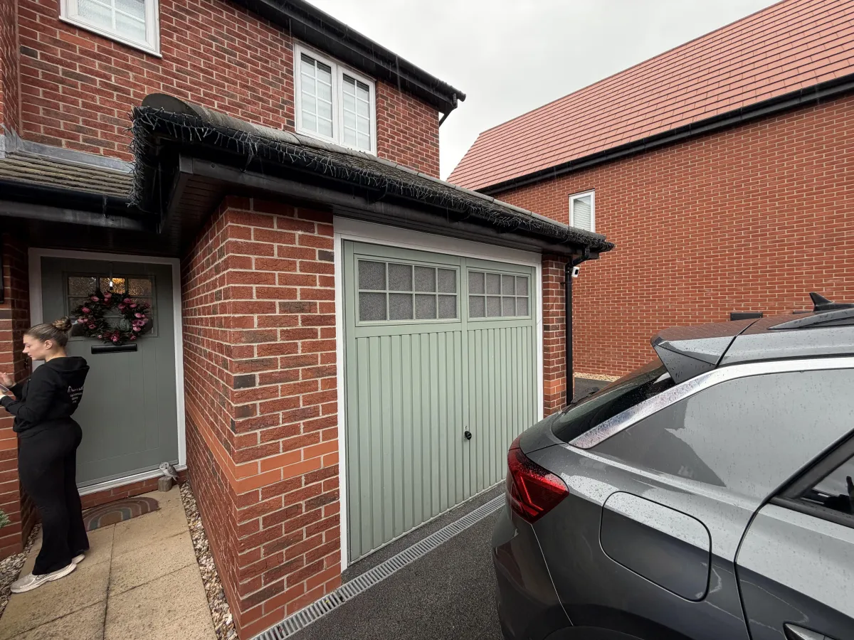Single garage conversion transformed into a children’s playroom with useful garage storage retained at the front behind the original garage door.