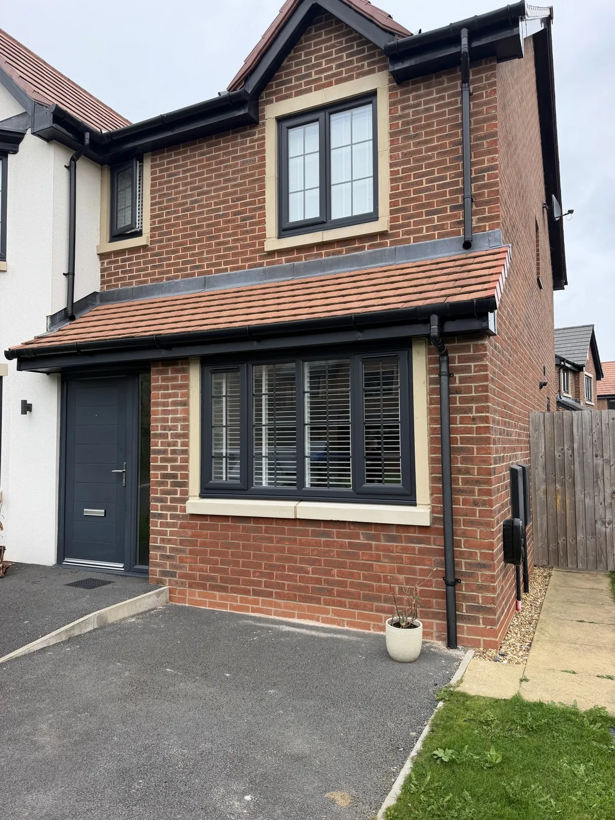 Garage conversion in Southport transformed into a children's playroom, featuring a new front window, matching brickwork and a modern exterior finish.